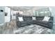 Open living room with sectional sofa, large TV, and adjacent kitchen view at 152 Apollo Dr, Rotonda West, FL 33947