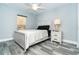 Cozy bedroom with a queen-size bed, nightstand, and ceiling fan at 152 Apollo Dr, Rotonda West, FL 33947