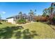 Large backyard with screened enclosure, lush landscaping, and plenty of space at 152 Apollo Dr, Rotonda West, FL 33947