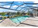 Screened pool and spa with patio furniture and canal view at 15576 Aldama Cir, Port Charlotte, FL 33981