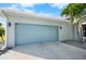 Attached garage with light gray door at 15674 Applewhite Cir, Port Charlotte, FL 33981