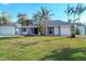 Newly renovated home with a spacious front yard and palm trees at 165 Spyglass Aly, Placida, FL 33946