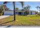 Newly renovated home with a spacious front yard and palm trees at 165 Spyglass Aly, Placida, FL 33946