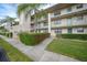 Two-story condo building with lush landscaping and walkways at 175 Kings Hwy # 236, Punta Gorda, FL 33983