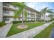 Building exterior with lush landscaping and walkway at 175 Kings Hwy # 236, Punta Gorda, FL 33983