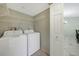 Bright laundry room with washer and dryer, and extra shelving at 175 Kings Hwy # 236, Punta Gorda, FL 33983
