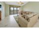 Living room with view of balcony and access to outside at 175 Kings Hwy # 236, Punta Gorda, FL 33983