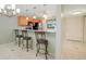 Open kitchen with breakfast bar, wood cabinets and view into living area at 175 Kings Hwy # 236, Punta Gorda, FL 33983