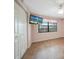Bedroom with wood floors, large window, and a mounted TV at 175 Kings Hwy # 236, Punta Gorda, FL 33983