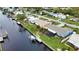 Aerial view showcasing canal-front home, pool, and dock at 189 Carlisle Nw Ave, Port Charlotte, FL 33952
