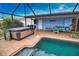Inviting pool and hot tub with patio furniture and grill at 189 Carlisle Nw Ave, Port Charlotte, FL 33952