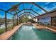 Relaxing pool area with covered patio, spa, and outdoor seating at 189 Carlisle Nw Ave, Port Charlotte, FL 33952