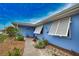 Cute Florida home with walkway, landscaping, and blue exterior at 189 Carlisle Nw Ave, Port Charlotte, FL 33952