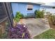 Relaxing patio area with ornate bench and tropical plants at 189 Carlisle Nw Ave, Port Charlotte, FL 33952