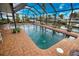 Enclosed pool with canal views and lush landscaping at 189 Carlisle Nw Ave, Port Charlotte, FL 33952