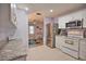 Updated kitchen boasts white cabinets, granite countertops, and stainless steel appliances at 189 Carlisle Nw Ave, Port Charlotte, FL 33952