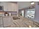 Kitchen with granite countertops, double sink, and view of the pool at 189 Carlisle Nw Ave, Port Charlotte, FL 33952