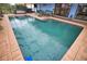 Refreshing screened-in pool with brick decking at 189 Carlisle Nw Ave, Port Charlotte, FL 33952