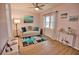 Bright living room features a comfy sofa, stylish rug, and large window at 189 Carlisle Nw Ave, Port Charlotte, FL 33952