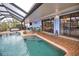 Inviting screened pool area with brick deck and canal views at 189 Carlisle Nw Ave, Port Charlotte, FL 33952