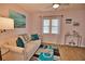 Bright living room features a comfy sofa, stylish rug, and large window at 189 Carlisle Nw Ave, Port Charlotte, FL 33952