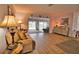 Living room with hardwood floors, neutral decor, and sliding doors leading to patio at 189 Carlisle Nw Ave, Port Charlotte, FL 33952