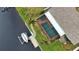 High-angle view of home's pool and canal-side dock at 189 Carlisle Nw Ave, Port Charlotte, FL 33952