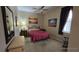 Cozy bedroom with double bed, nightstand, and rocking chair at 24412 Lakeview Pl, Punta Gorda, FL 33980