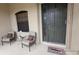 Inviting front porch with seating for two and a welcoming door at 24412 Lakeview Pl, Punta Gorda, FL 33980