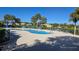 Community pool with lounge chairs and umbrellas at 24412 Lakeview Pl, Punta Gorda, FL 33980