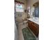 Clean bathroom with wood vanity, shower, and tile floor at 24412 Lakeview Pl, Punta Gorda, FL 33980