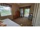 Charming bedroom with daybed, dresser, and private patio access at 24412 Lakeview Pl, Punta Gorda, FL 33980
