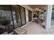 Covered patio with wicker furniture and sliding glass doors at 24412 Lakeview Pl, Punta Gorda, FL 33980