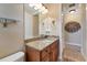 Small bathroom with granite countertop and wood cabinets at 28108 Pablo Picasso Dr, Englewood, FL 34223