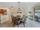 Bright dining room with patio access and chandelier at 28108 Pablo Picasso Dr, Englewood, FL 34223