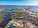 Aerial view of waterfront property with canal access and lush landscaping at 300 E Bay Heights Rd, Englewood, FL 34223