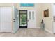 Inviting entryway with light teal door and view to backyard at 3075 Bay Oaks Cir, Englewood, FL 34223
