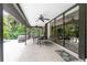 Covered patio with multiple seating areas and a view of the pool at 3075 Bay Oaks Cir, Englewood, FL 34223