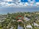 Aerial view of a single-Gathering home nestled in a lush, tropical landscape near the ocean at 3075 Bay Oaks Cir, Englewood, FL 34223