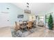 Bright dining room with a rustic table and six chairs at 3075 Bay Oaks Cir, Englewood, FL 34223