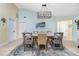 Elegant dining room with a large chandelier and seating for six at 3075 Bay Oaks Cir, Englewood, FL 34223