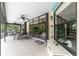 Covered patio with seating area, views of the pool and lush landscaping at 3075 Bay Oaks Cir, Englewood, FL 34223