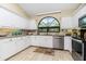 Updated kitchen with white cabinets and granite countertops at 3075 Bay Oaks Cir, Englewood, FL 34223