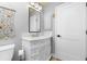 Bathroom with a white vanity, updated fixtures and a large mirror at 3075 Bay Oaks Cir, Englewood, FL 34223