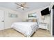 Light and airy bedroom with a queen-size bed, ceiling fan, and plenty of closet space at 3075 Bay Oaks Cir, Englewood, FL 34223
