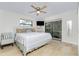 Primary bedroom with a king-size bed, private access to the patio, and ceiling fan at 3075 Bay Oaks Cir, Englewood, FL 34223