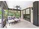 Relaxing screened-in patio with lounge chairs, perfect for outdoor enjoyment at 3075 Bay Oaks Cir, Englewood, FL 34223