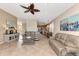 Open living room with kitchen views, comfortable sofas, and ceiling fan at 3393 Grand Vista Ct # 201, Port Charlotte, FL 33953