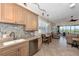Modern kitchen with stainless steel appliances and light wood cabinets at 3393 Grand Vista Ct # 201, Port Charlotte, FL 33953