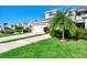 Two-story house exterior with a garage and lush landscaping at 3393 Grand Vista Ct # 201, Port Charlotte, FL 33953